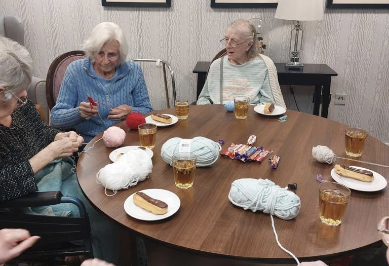 Our residents knitting blankets for a dog home at Ty Llandaff Care Home
