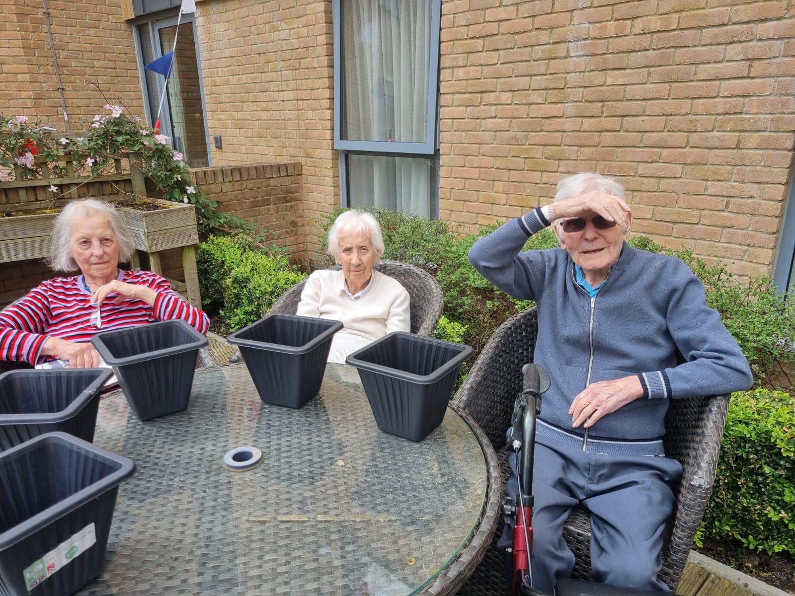 Our residents with plants at our gardening club at Ty Llandaff Care Home