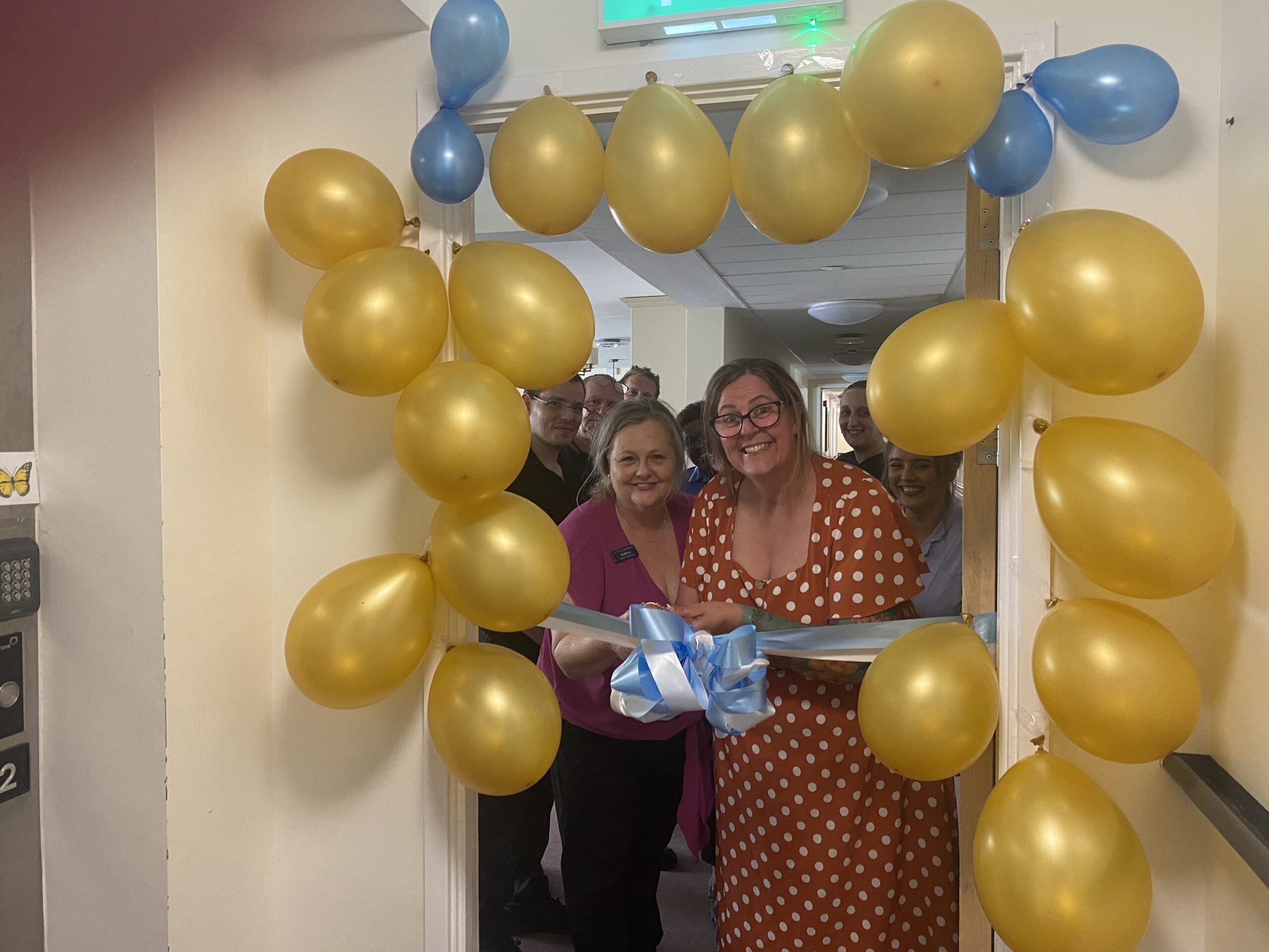 Our team cutting the ribbon at the Grand Opening of our new Nursing Unit at Ty Llandaff